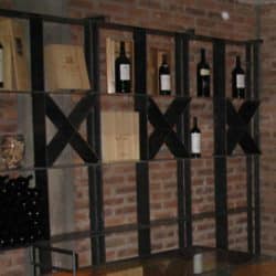2 free standing wine racks with big bottle of wine on them