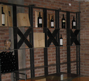 2 free standing wine racks with big bottle of wine on them